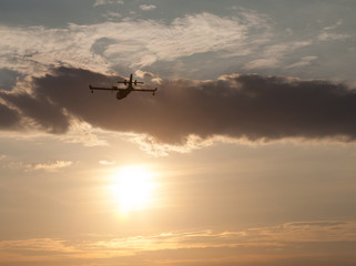 Fototapeta na wymiar Silhouette of an airplane at sunset.