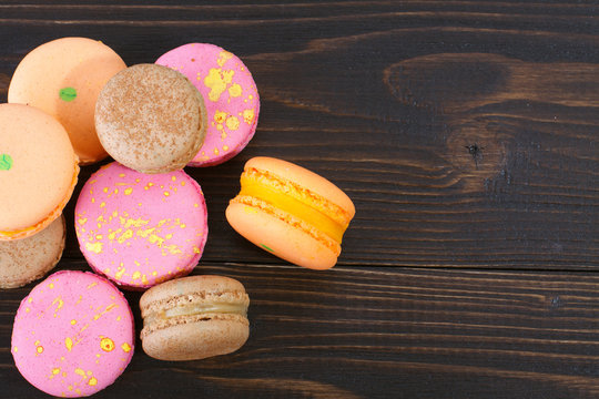 Colorful macarons on a wooden background