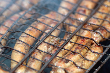 preparing sausages on fire