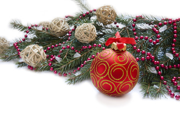 Fototapeta na wymiar Christmas red ball, twig of fir , beads