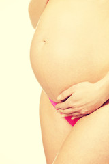 Fototapeta na wymiar Pregnant woman touching belly