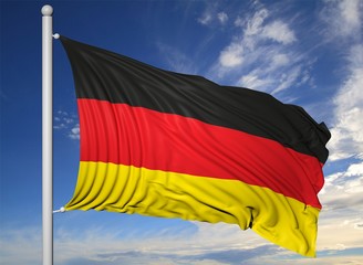 Waving flag of Germany on flagpole, on blue sky background.