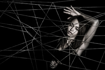 Young woman entangled the net of ropes