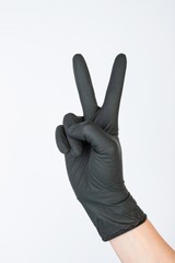 Hand in black medical glove. Stock image macro.