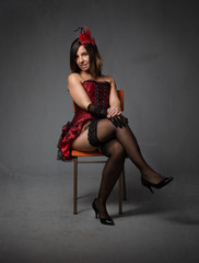 burlesque woman sitting with crossing legs