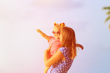 mother and cute little daughter at beach
