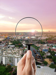 Magnifying glass and cityscape in focus, business vision