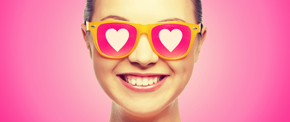 smiling teenage girl in pink sunglasses
