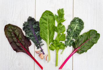 Range of healthy green vegetable on a white table