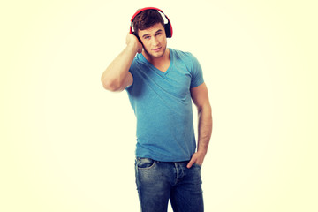 Handsome man listening to music with headphones.