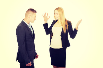 Pregnant businesswoman arguing with her partner