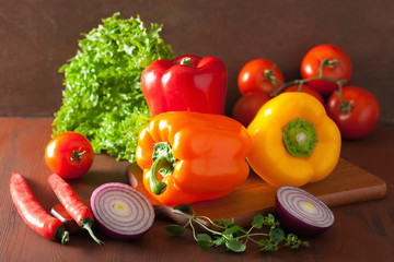 healthy vegetables pepper tomato salad onion on rustic backgroun