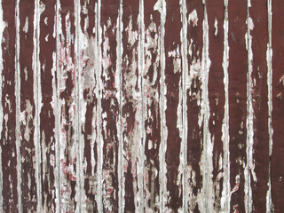 Old brown paint coming off wooden boards