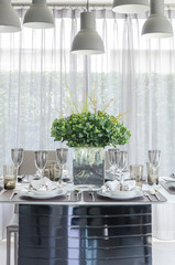 table set with glass vase of flower