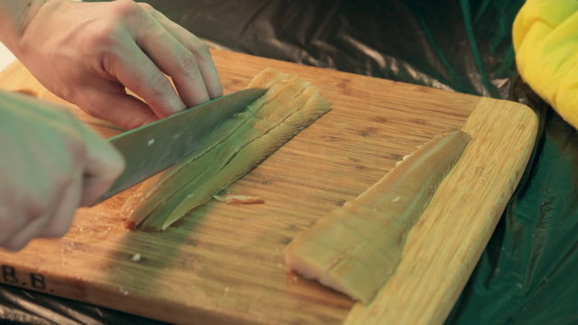 The process of cutting delicious fat smoked fish into cubes
