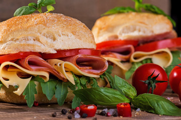 Italian ciabatta with ham and cheese on the wooden background