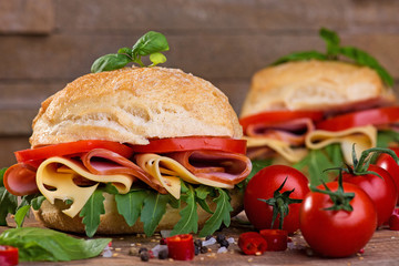 Italian ciabatta with ham and cheese on the wooden background