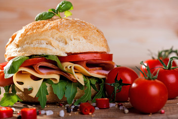 Italian ciabatta with ham and cheese on the wooden background