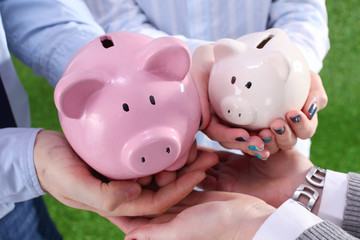 Piggy Bank in hands of a family