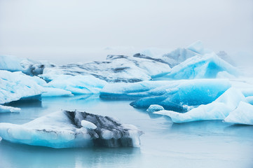 Fototapeta na wymiar Beautiful blue icebergs in Jokulsarlon glacial lagoon, Iceland