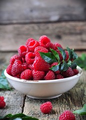 organic raspberries on a wooden background