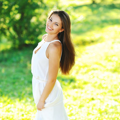 Beautiful smiling girl in white dress outdoor