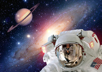 Astronaut spaceman helmet outer space suit saturn planet universe. Elements of this image furnished...