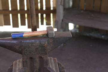 Fototapeta na wymiar Hammer and anvil at blacksmith