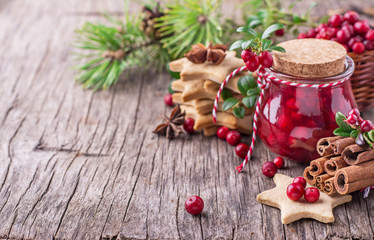 Cranberry sauce in a glass on wooden board