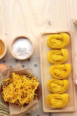 Making yellow noodle with egg and wheat flour.
