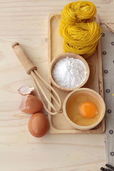 Making yellow noodle with egg and wheat flour.