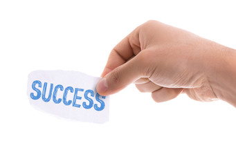 Piece of paper with the word Success isolated on white background