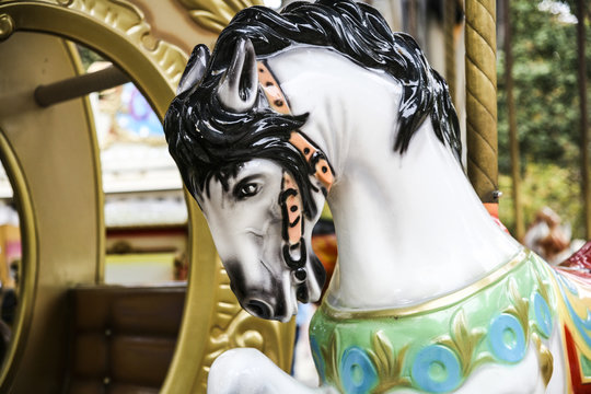 A vintage carousel horse in a park in Paris France.