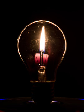 Lightbulb and candle flame