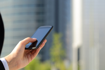 Business woman hand texting on he smart phone