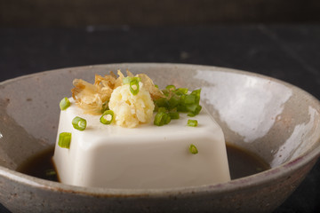 Japanese tofu, Japanese soft cold tofu with sauce in a dish on dining table