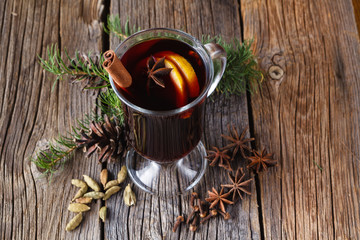 Mulled wine and spices on rustic wooden table