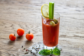 Bloody Mary cocktail on the wooden background