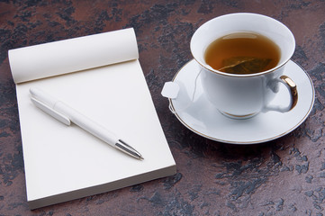 Tea and opened notebook