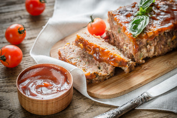 Meat loaf with barbecue sauce on the wooden board