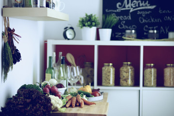 Young woman standing near desk in the kitchen