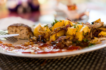 fried potatoes with a chop