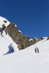 Snowboarders walking uphill for freeride