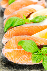 Salmon on stone with basil and lemon