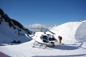 White rescue helicopter parked in the mountains