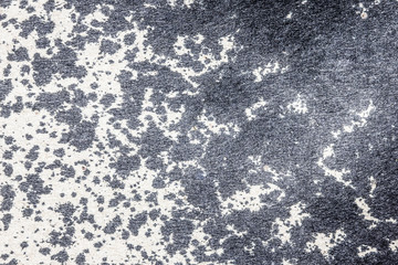 Black stains on gray paper texture.