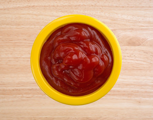 Ketchup filling a small yellow bowl