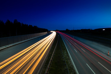 Light trails from car on highway