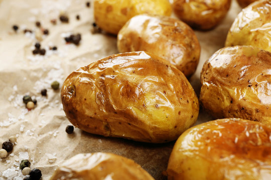 Baked spicy potatoes on parchment, closeup