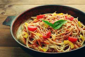 Homemade Spaghetti Bolognese on pan, on wooden background